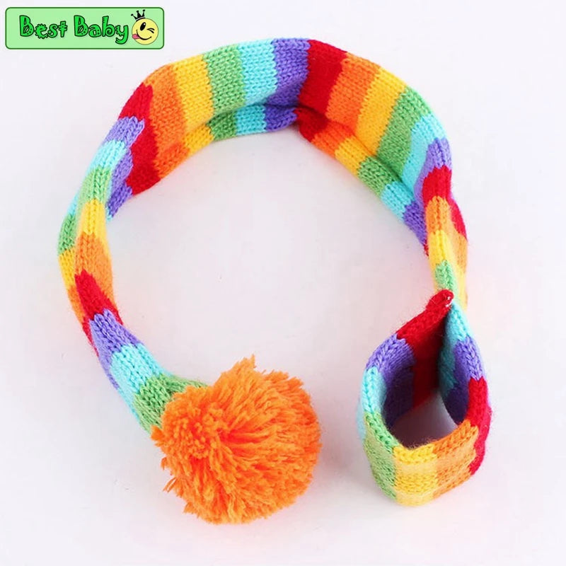 Colorful knitted scarf with a pom-pom on a white background.