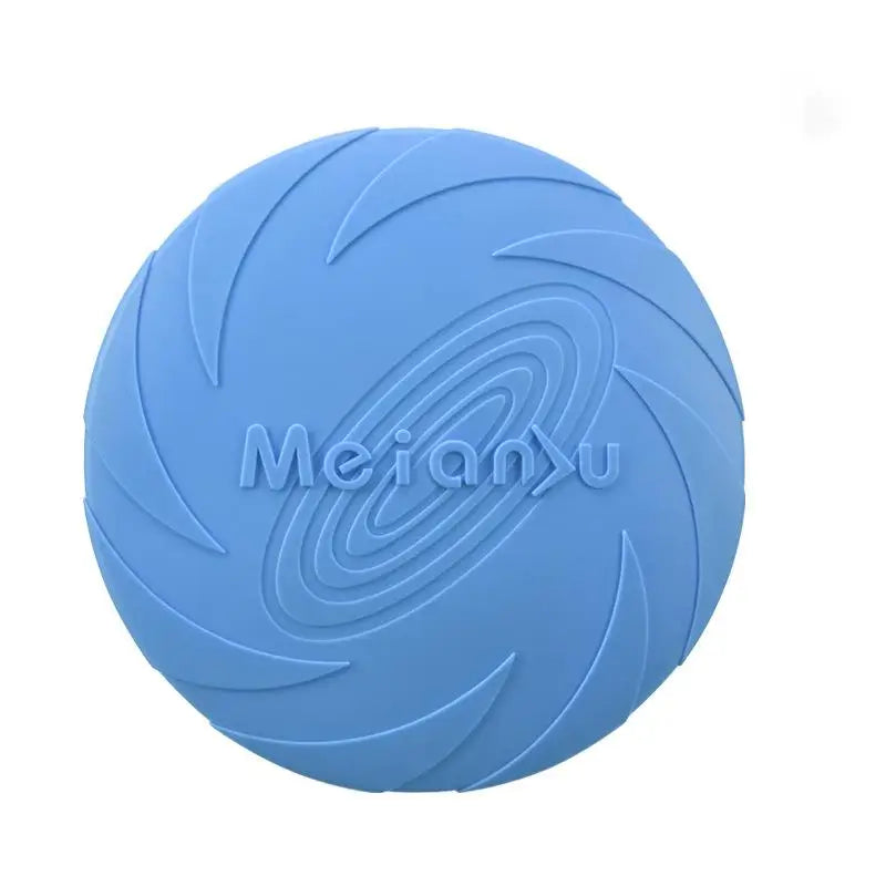 A dog catching a blue flying disc with more discs in orange and purple lying on the ground.