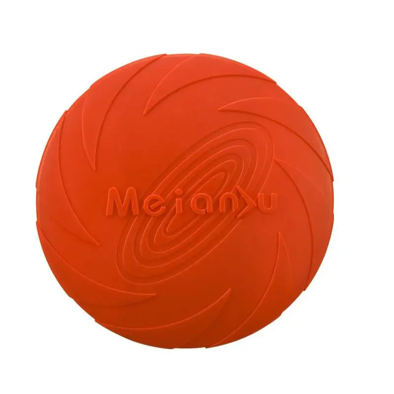 A dog catching a blue flying disc with more discs in orange and purple lying on the ground.