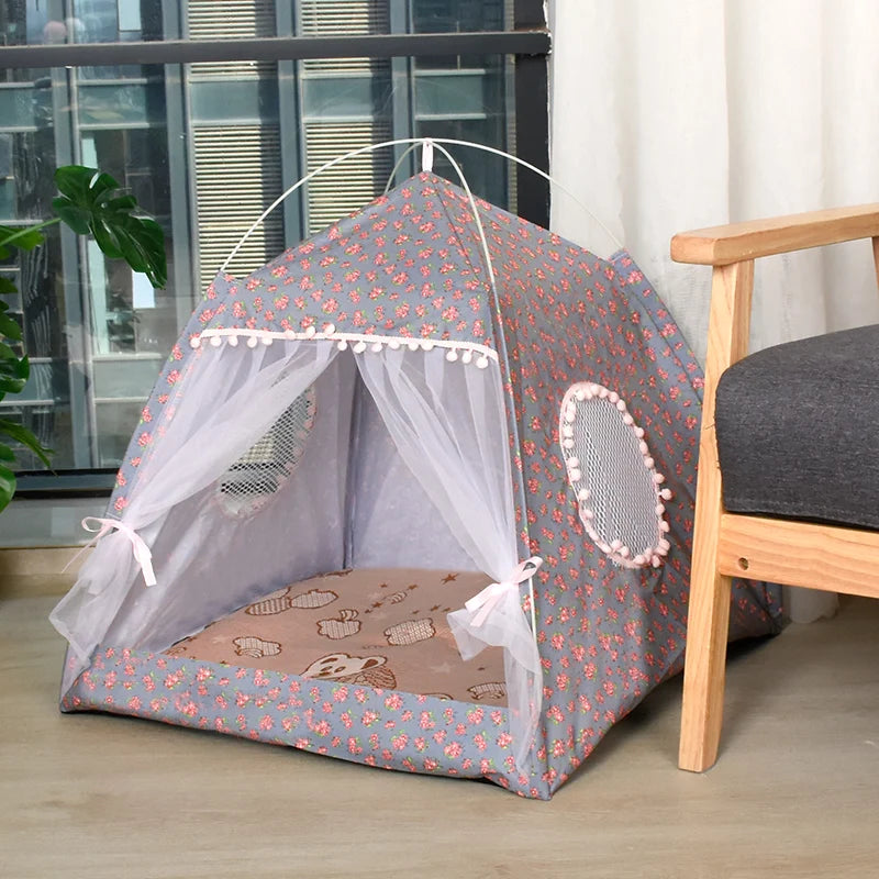 Cats play tent with floral pattern on a wooden floor.