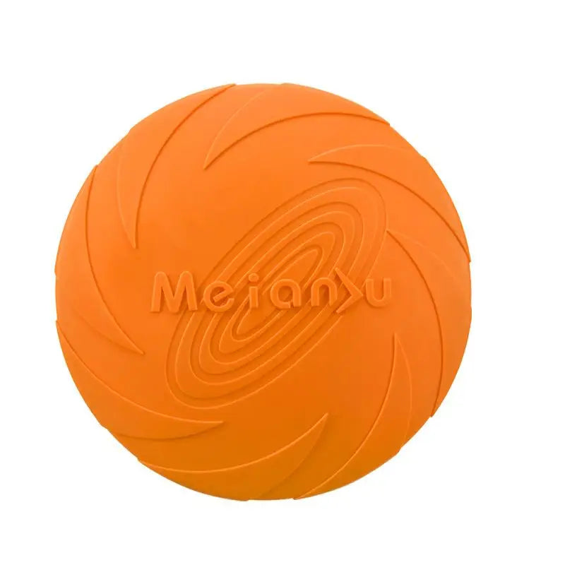 A dog catching a blue flying disc with more discs in orange and purple lying on the ground.