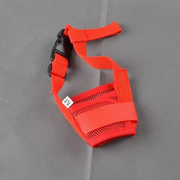 A dog muzzle in red color, made of nylon,