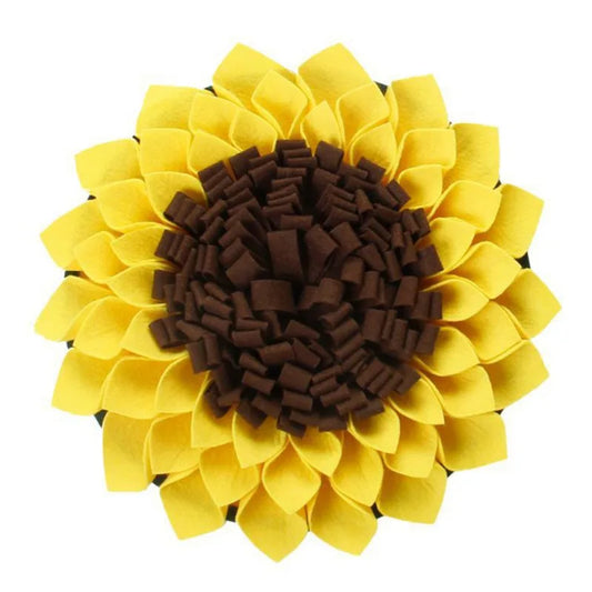 A flat lay of a yellow and brown dog snuffle mat designed to resemble a flower, with textured fabric for dogs to search for treats.